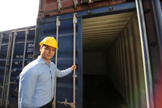 Engineer or supervisor checking and control loading Containers box from Cargo at harbor.Foreman control Industrial Container Cargo freight ship at industry.Transportation and logistic concept. 