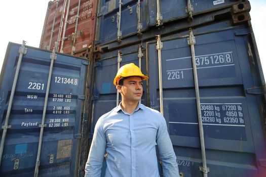 Engineer or supervisor checking and control loading Containers box from Cargo at harbor.Foreman control Industrial Container Cargo freight ship at industry.Transportation and logistic concept. 
