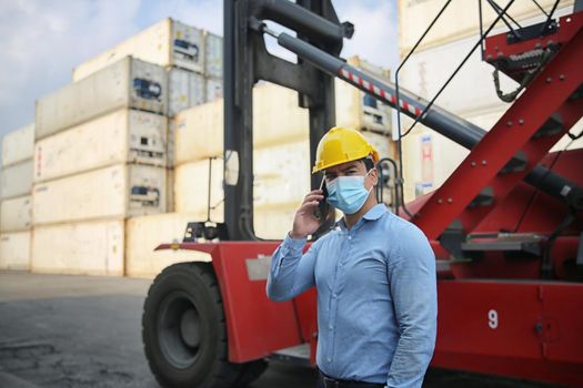Factory industry worker working with face mask to prevent Covid-19 Coronavirus spreading during job reopening period .