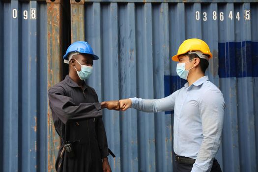 Factory industry worker working with face mask to prevent Covid-19 Coronavirus spreading during job reopening period .