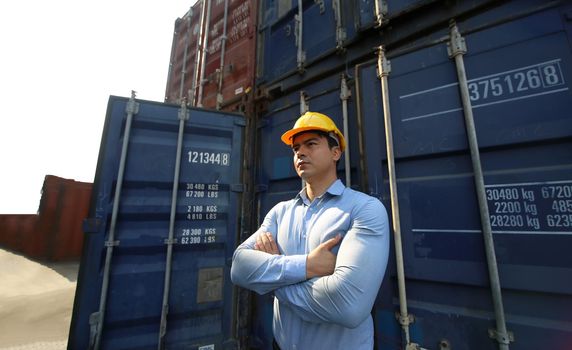 Foreman control loading Containers box from Cargo freight ship for import export.