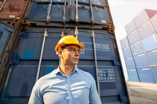 Foreman control loading Containers box from Cargo freight ship for import export.