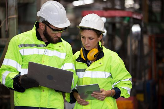 Portrait woman worker and engineer under inspection and checking production process on factory station