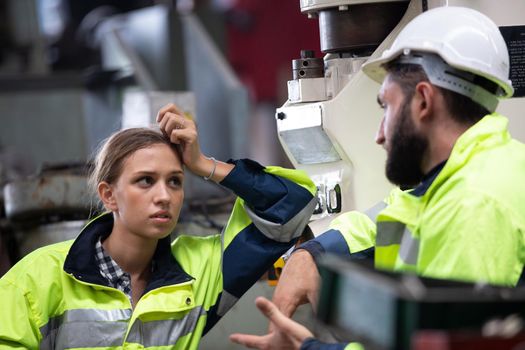 Portrait woman worker and engineer under inspection and checking production process on factory station