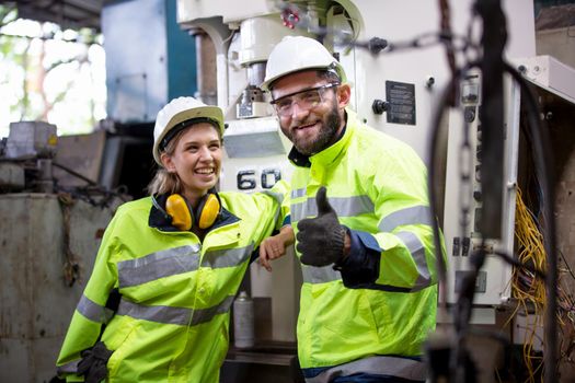 Portrait woman worker and engineer under inspection and checking production process on factory station