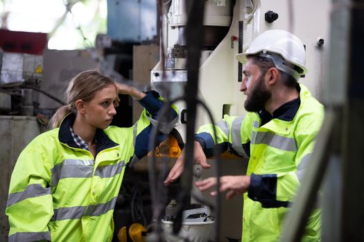 Portrait woman worker and engineer under inspection and checking production process on factory station