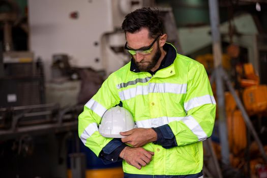 workers helmets at the factory, workers in the factory, people go in helmets and uniforms for an industrial enterprise