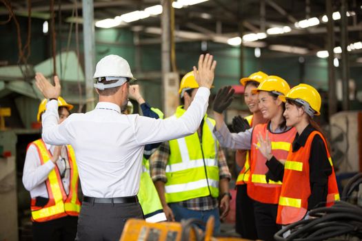 group of workers, change of workers in the factory, people go in helmets and uniforms for an industrial enterprise