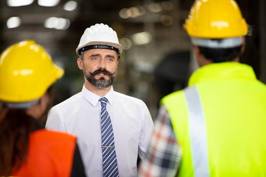 group of workers, change of workers in the factory, people go in helmets and uniforms for an industrial enterprise