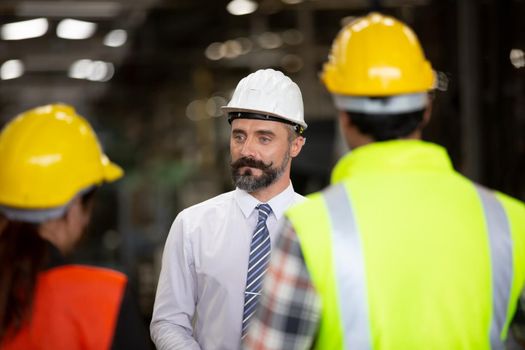 group of workers, change of workers in the factory, people go in helmets and uniforms for an industrial enterprise