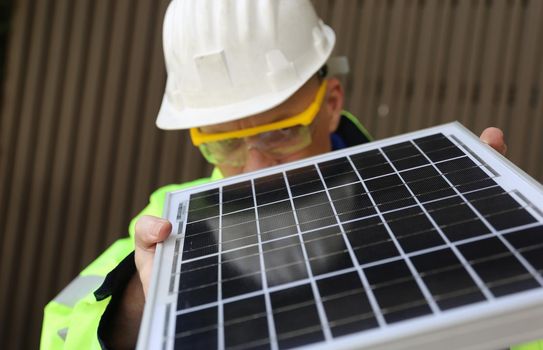 maintenance engineer, Solar energy systems engineer perform analysis solar panels, Portrait of engineer man or worker, people, with solar panels or solar cells on the roof in farm. Power plant with green field, renewable energy source in American. Eco technology for electric power.
