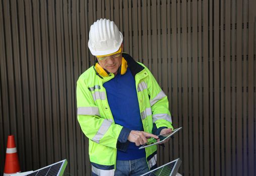 maintenance engineer, Solar energy systems engineer perform analysis solar panels, Portrait of engineer man or worker, people, with solar panels or solar cells on the roof in farm. Power plant with green field, renewable energy source in American. Eco technology for electric power.