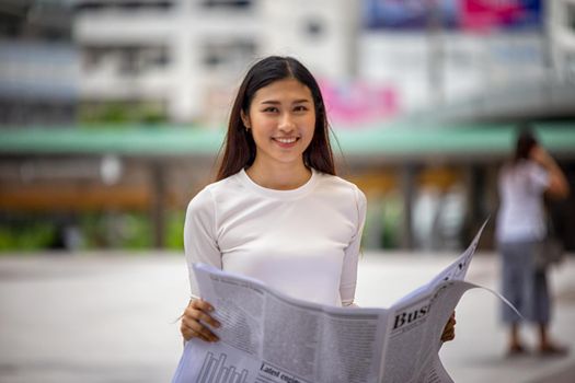 business people reading business newspaper at outdoor.