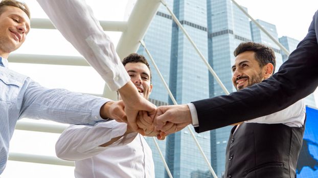 Business partners or group of diverse students put fists in circle fist bump as symbol of engagement in team building, support and synergy, help in cooperation, trust unity in teamwork, close up image