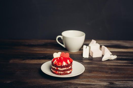 Round red cake In a saucer a cup of tea sweets delight candy. High quality photo