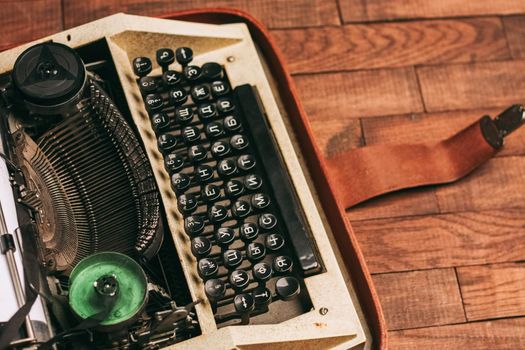 typewriter with keys on a wooden background retro style close-up macro. High quality photo