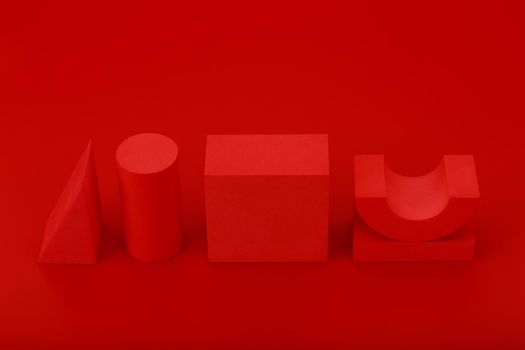 Abstract red geometric background with copy space. High angle view of red geometric figures against red background. Variety of red geometric figures