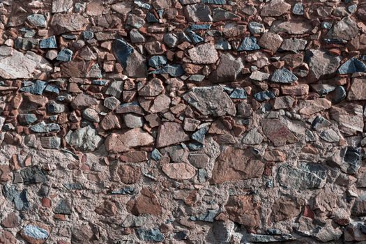 Stone wall of an old house in a village in southern Andalusia in Spain