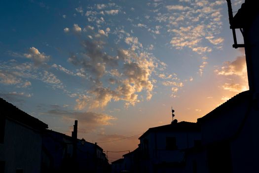 Sunset in a village with houses back lighting Andalusian in southern Spain in July