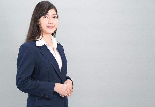 Portrait of asian business woman standing isolated on gray background