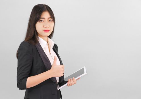 Young women standing in suit holding her digital tablet computor
