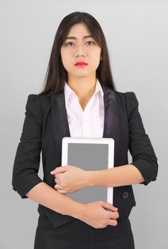 Young women standing in suit holding her digital tablet computor