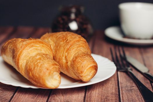 croissant in a plate on the table kitchenware breakfast meal dessert. High quality photo
