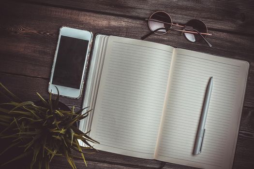 notebook with pen work desk sunglasses phone technology. High quality photo
