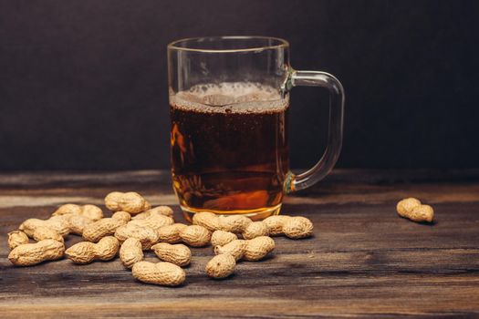 beer mug peanuts in shells bar wood counter alcoholic beverage like. High quality photo