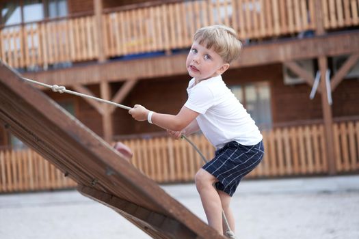 Boy play playground Child climbing rope outdoor Children healthy summer activity Healthy growth