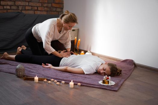 Relax and enjoy in spa salon getting thai massage by professional masseur Woman lying floor blanket Body care Hands treatment Acupressure trigger points Prevention muscles pain stretching flexibility