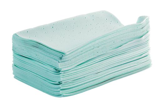 stack of green liquidless and powderless laundry detergent squares sheets isolated on white background.