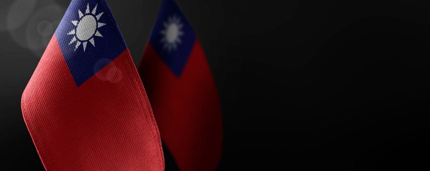 Small national flags of the Taiwan on a dark background.