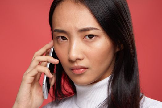 brunette with disgruntled expression talking on the phone technology emotions close-up. High quality photo