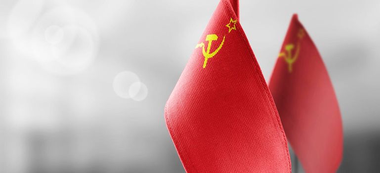 Small national flags of the USSR on a light blurry background.