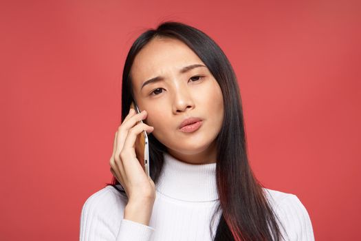 national woman talking on the phone technology studio red isolated background. High quality photo