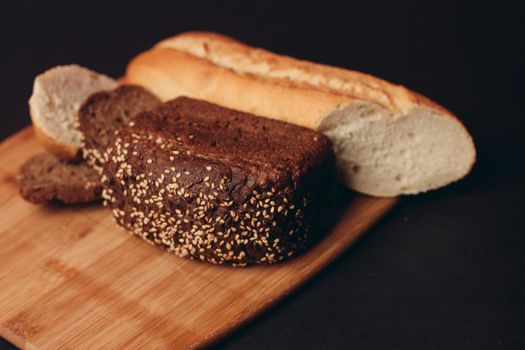 flour products loaf of bread baguette and pastries on wooden board. High quality photo