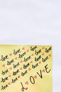 Love handwriting text close up isolated on yellow paper with copy space.