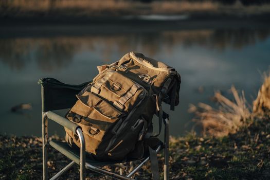 backpacker bag folding chair nature lake travel outdoor. High quality photo