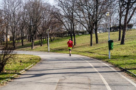 Jogging, running in the city park. Healthy lifestyle, outdoor physical activity and fitness concept in Bucharest, Romania, 2021