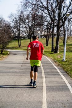 Jogging, running in the city park. Healthy lifestyle, outdoor physical activity and fitness concept in Bucharest, Romania, 2021