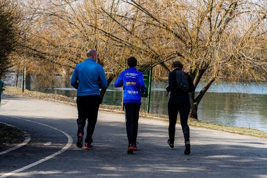 Jogging, running in the city park. Healthy lifestyle, outdoor physical activity and fitness concept in Bucharest, Romania, 2021