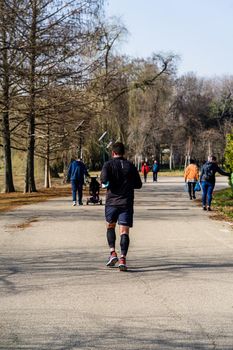 Jogging, running in the city park. Healthy lifestyle, outdoor physical activity and fitness concept in Bucharest, Romania, 2021