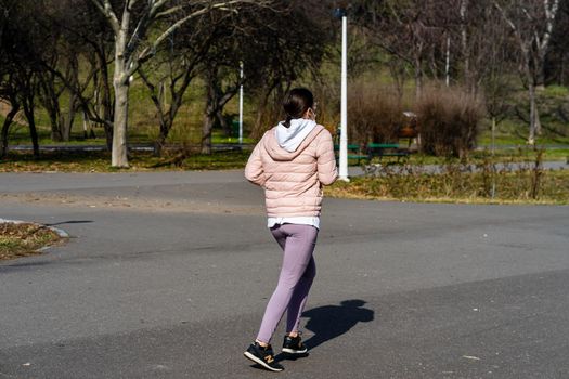 Jogging, running in the city park. Healthy lifestyle, outdoor physical activity and fitness concept in Bucharest, Romania, 2021