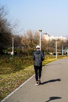 Jogging, running in the city park. Healthy lifestyle, outdoor physical activity and fitness concept in Bucharest, Romania, 2021