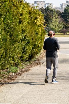 Jogging, running in the city park. Healthy lifestyle, outdoor physical activity and fitness concept in Bucharest, Romania, 2021