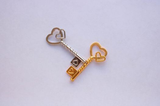 Gold and silver keys isolated on a white background.