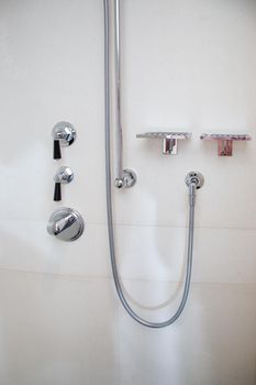 Chrome metal shower faucets in the bathroom.