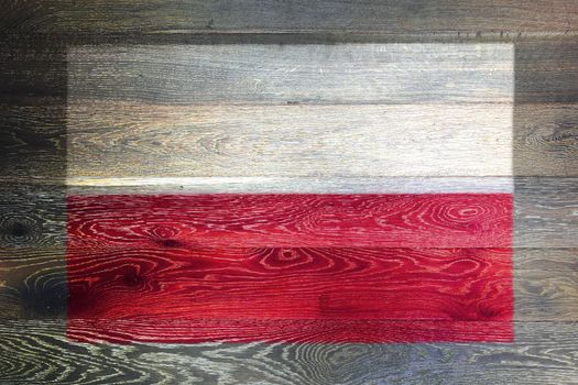 A Poland flag on rustic old wood surface background
