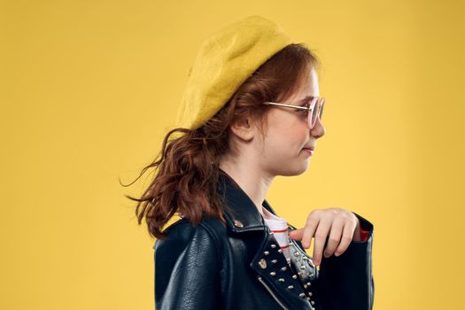 Girl in a yellow hat dark glasses fashionable clothes studio lifestyle childhood. High quality photo